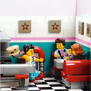 LEGO people in a diner setting with checkered floor and wall decorations.