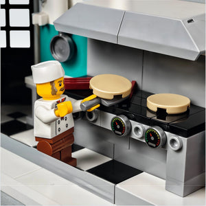 LEGO chef character cooking on a stove with LEGO kitchen set
