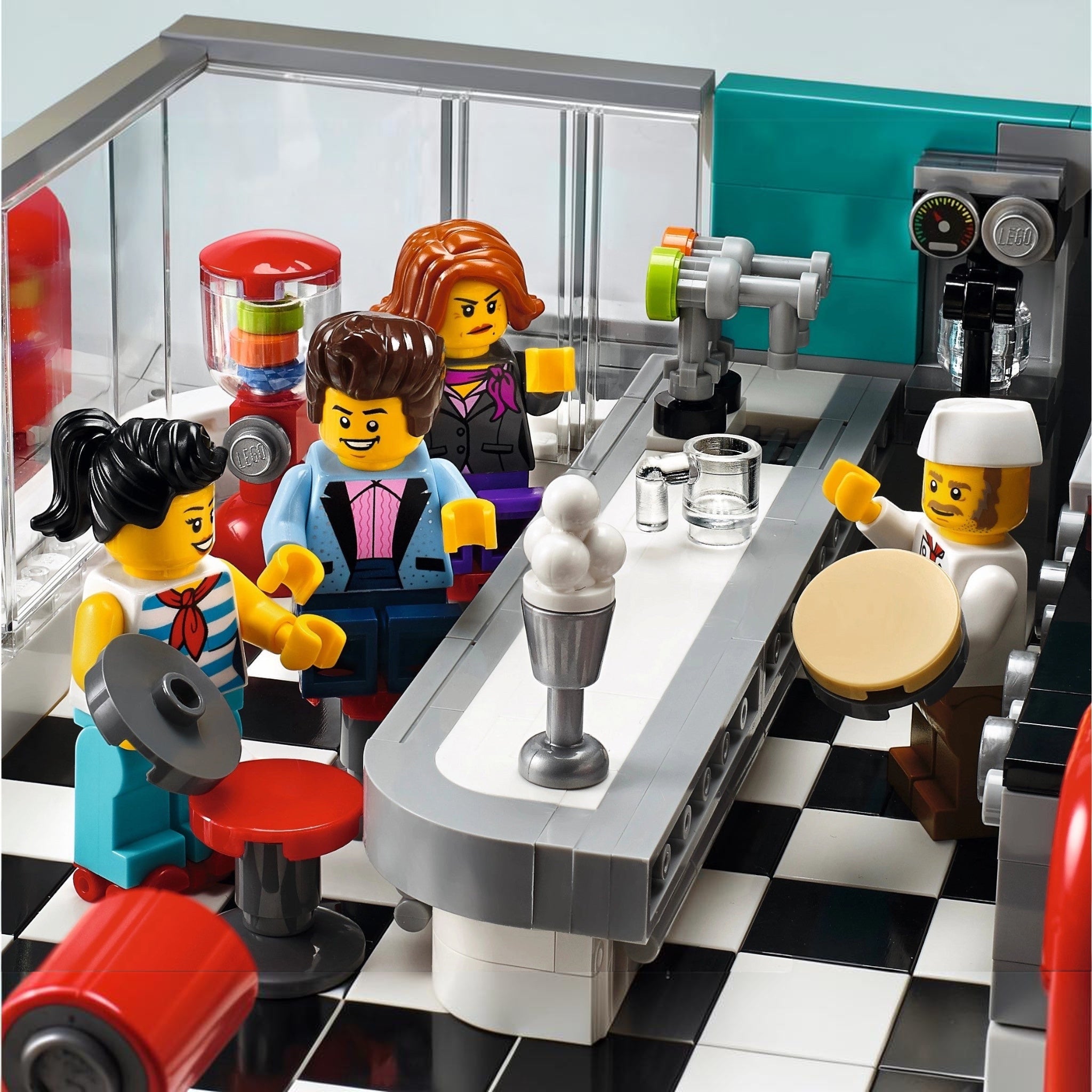 LEGO minifigures in a coffee shop setting with a barista and customers.