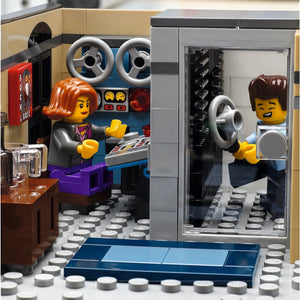 LEGO model of a car interior with two minifigures inside, one driving and one sitting.