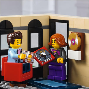 Two LEGO figures in a room with a jukebox and wall decorations.