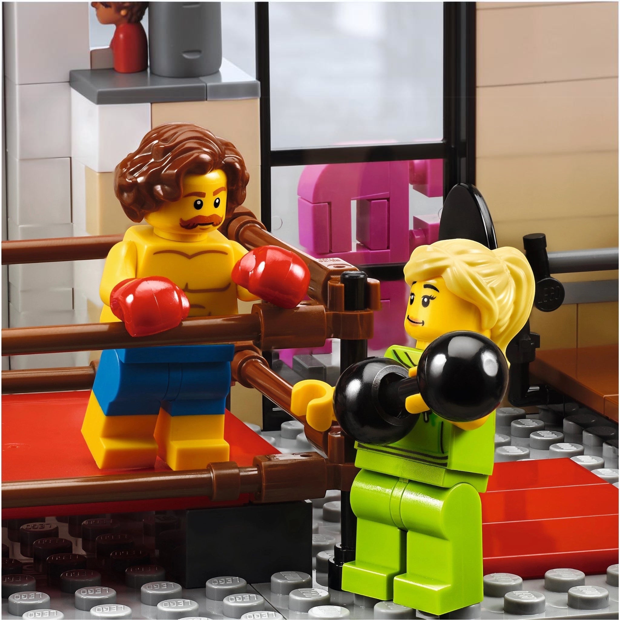 Two LEGO figures in a boxing match inside a LEGO ring.