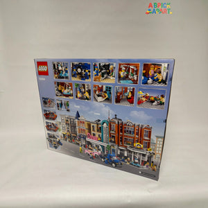 LEGO set box with various minifigure images and a city street scene on a white background