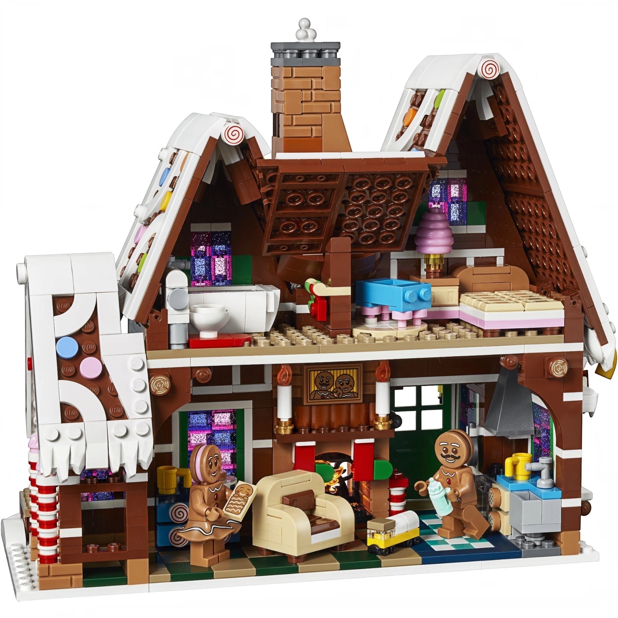 Toy gingerbread house with detailed interior and characters on a white background