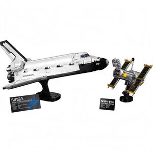Model of a space shuttle and satellite with NASA branding on a white background