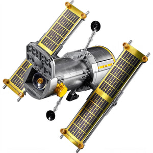 Model of a satellite with solar panels on a white background