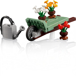 LEGO set with a watering can, table, and potted flowers on a white background