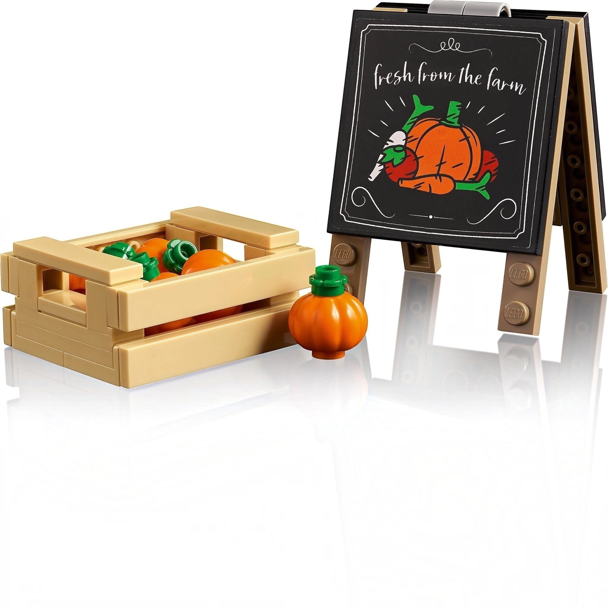 Toy crate with pumpkins and a small easel with a 'fresh from the farm' sign on a white background