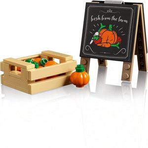 Toy crate with pumpkins and a small easel with a 'fresh from the farm' sign on a white background