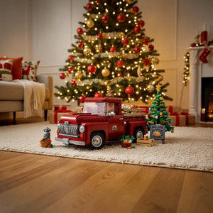 Red toy truck in a living room with a decorated Christmas tree and presents.