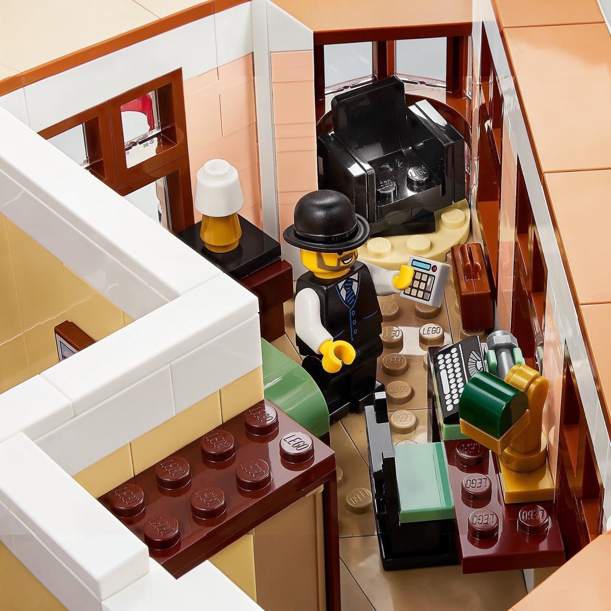 Close-up of a LEGO scene with a character in a bar setting, including a cash register and drinks.