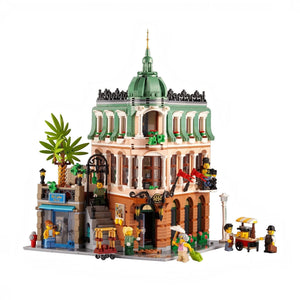 Detailed LEGO model of a building with green dome and people figures on a white background