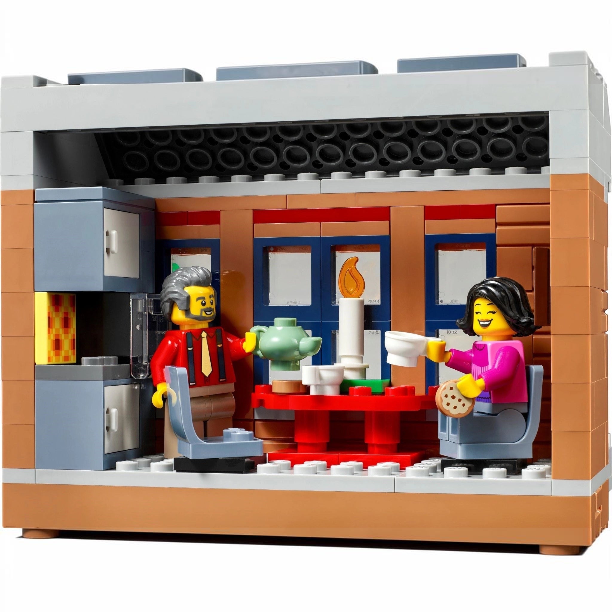 LEGO model of a cafe interior with two characters and various props.