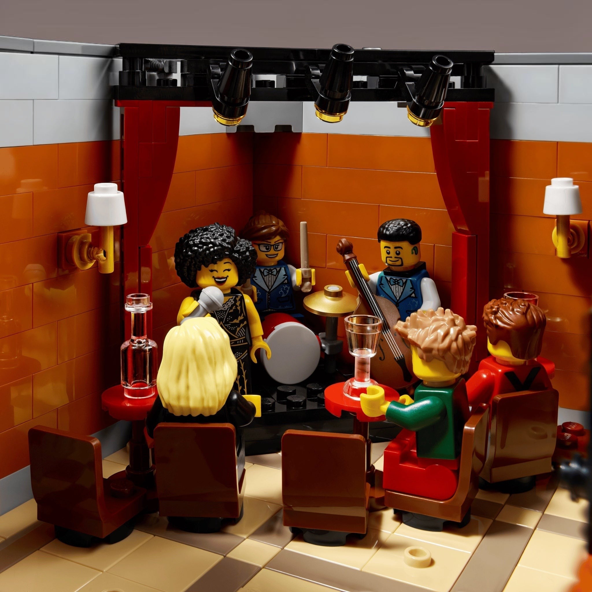 LEGO set with characters in a bar setting, complete with furniture and props.