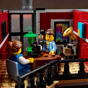 LEGO scene with two characters in a room with scientific equipment and a computer.
