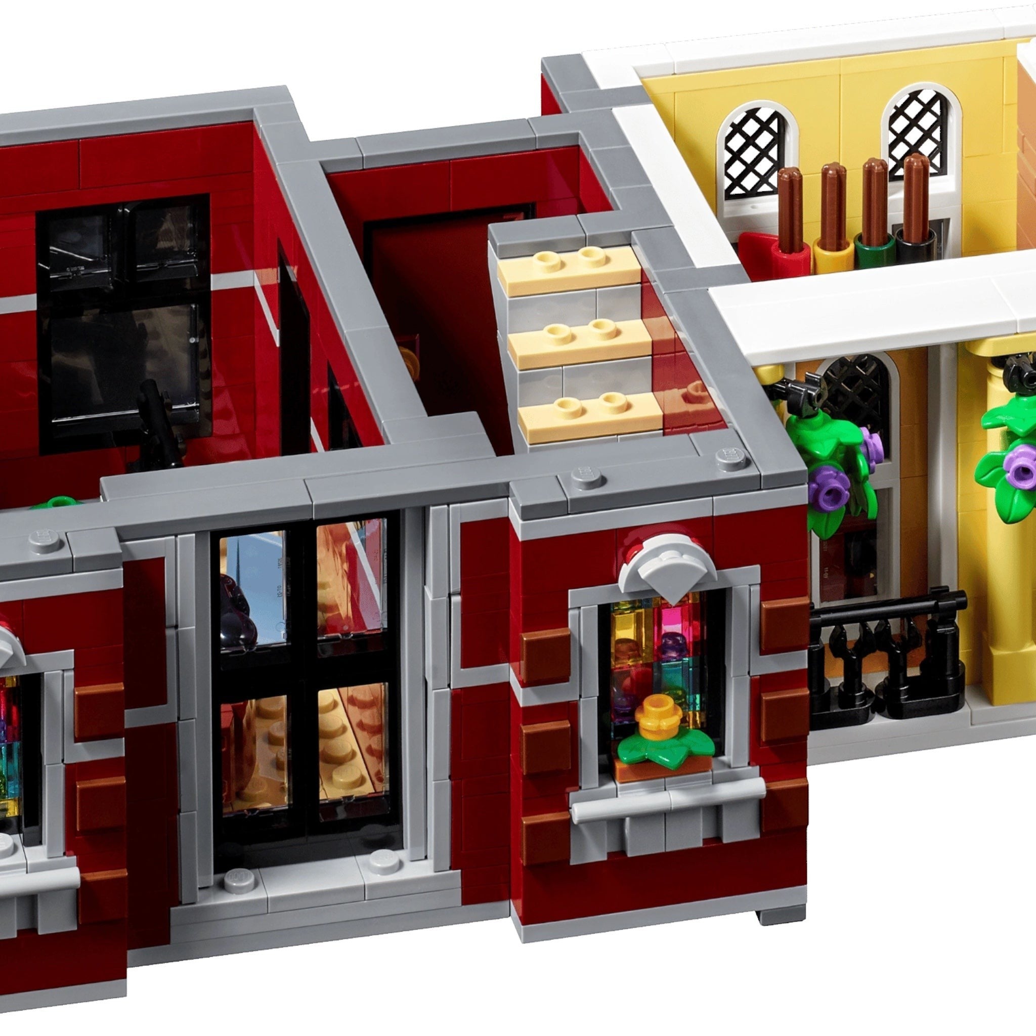LEGO model of a two-story building with red and yellow facade