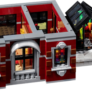Toy building set with detailed interior and exterior, featuring a red facade and glass windows.