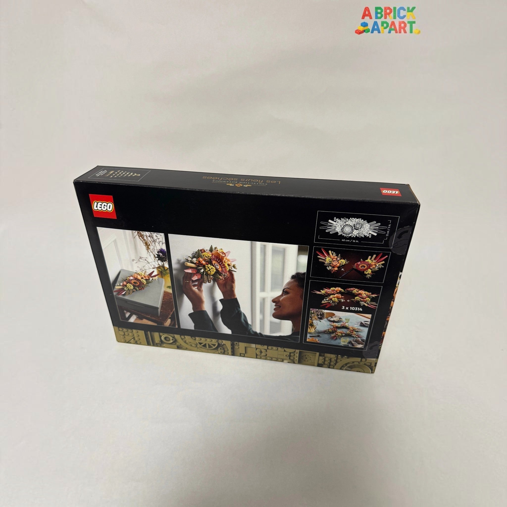 LEGO set packaging with images of a woman arranging flowers and LEGO pieces.
