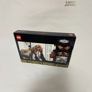 LEGO set packaging with images of a woman arranging flowers and LEGO pieces.
