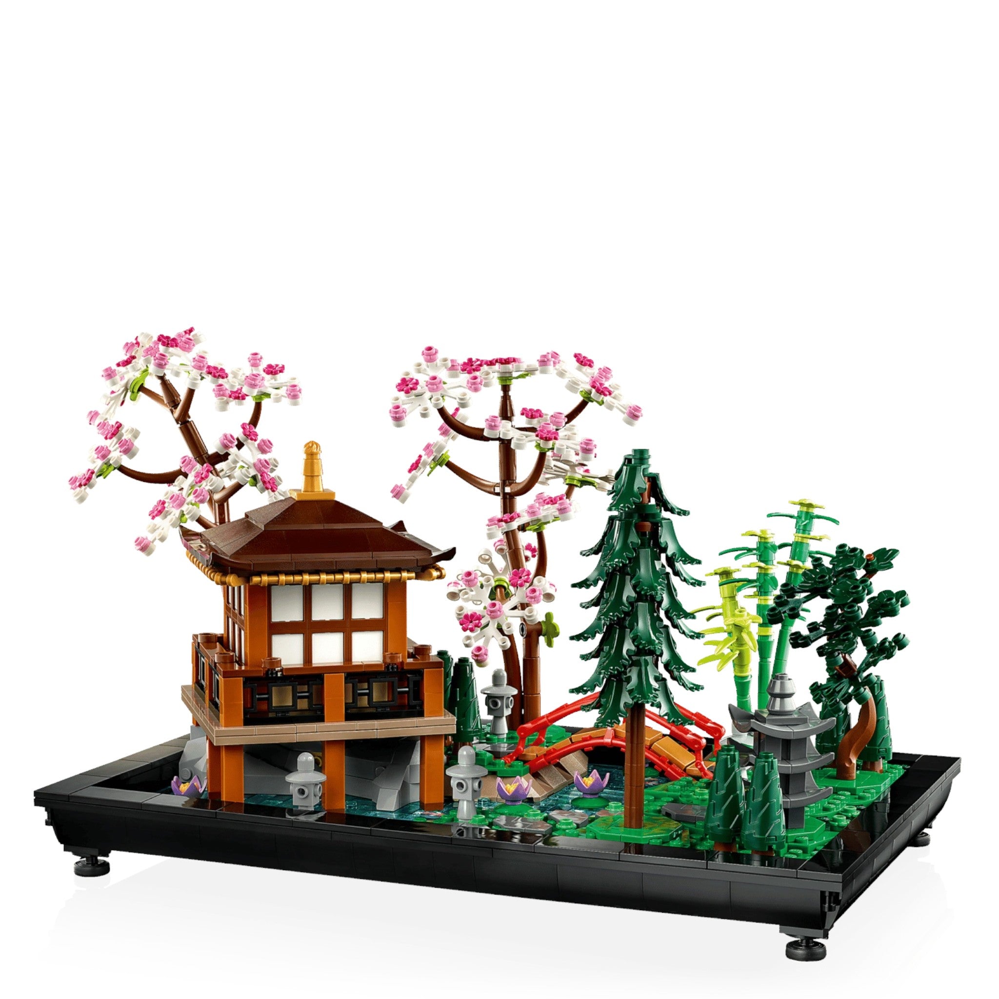 LEGO model of a Japanese-style building with cherry blossom trees and greenery on a white background
