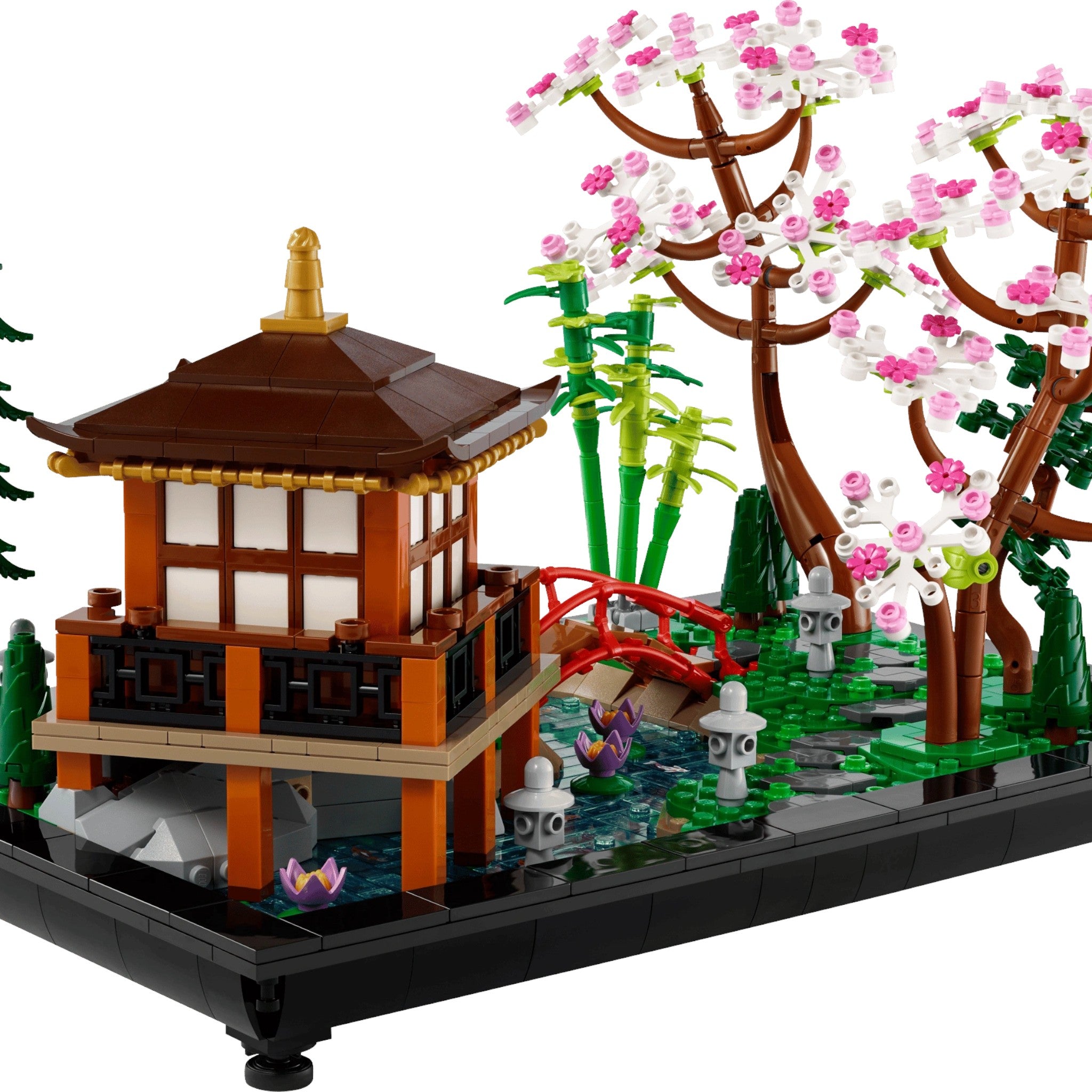 LEGO model of a Japanese-style building with cherry blossom tree and bridge on a transparent background