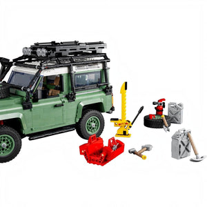 LEGO model of a green SUV with various accessories on a white background