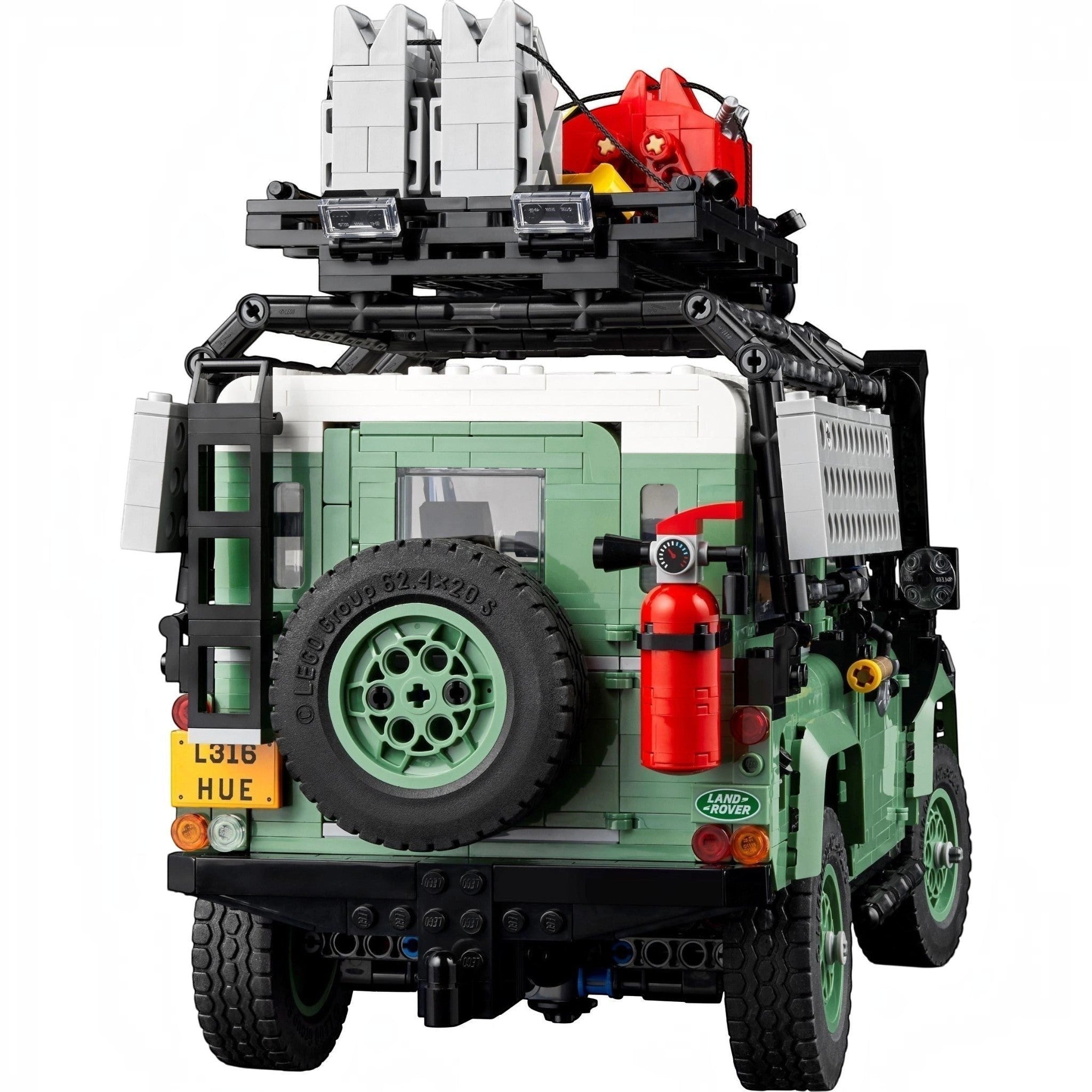 LEGO model of a vehicle with green body, black tires, and red fire extinguisher on a white background