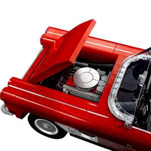 Close-up of a red car model with an open hood on a white background