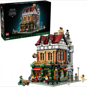 LEGO building set with detailed architecture and people figures, next to its packaging.
