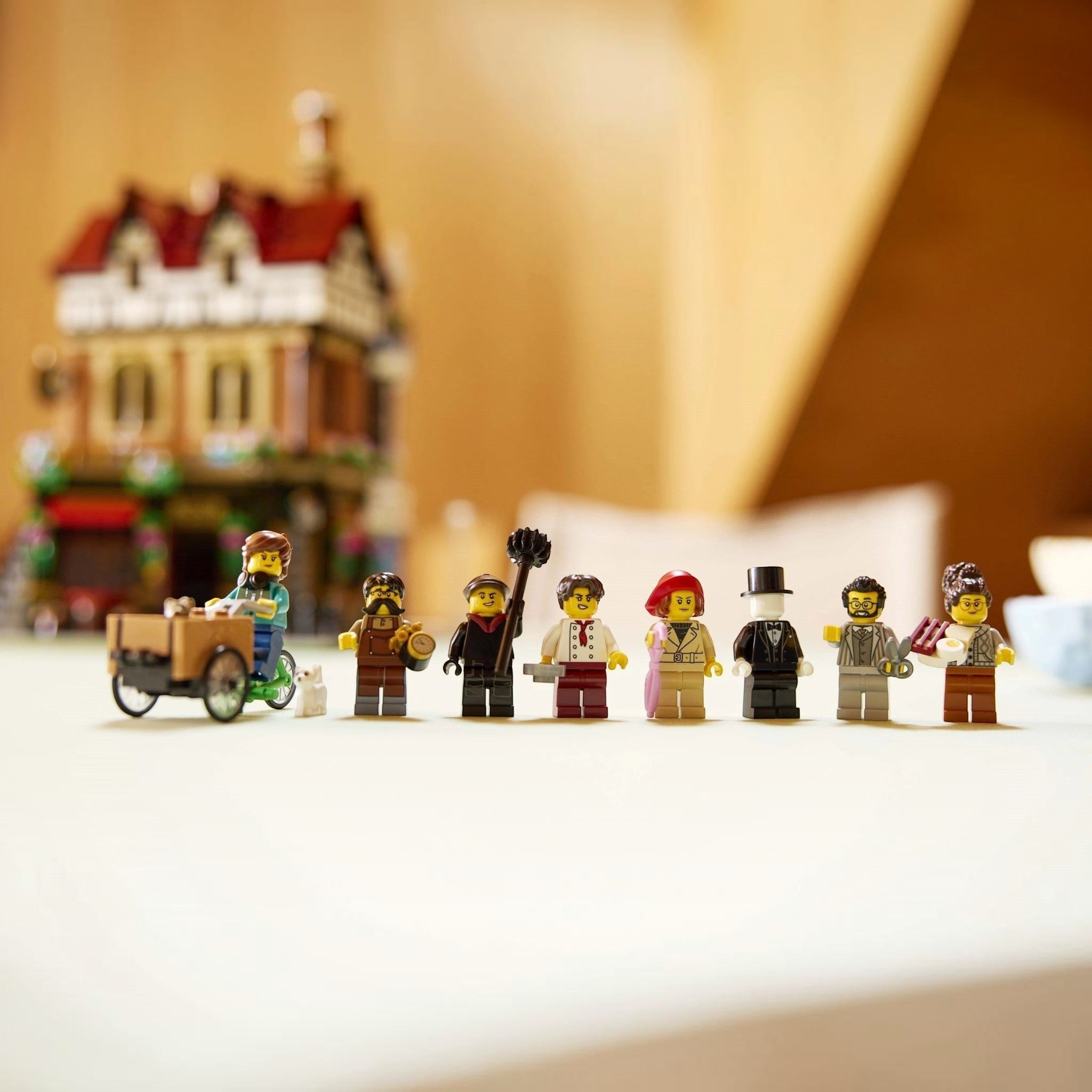 Row of LEGO figures in front of a blurred toy town background