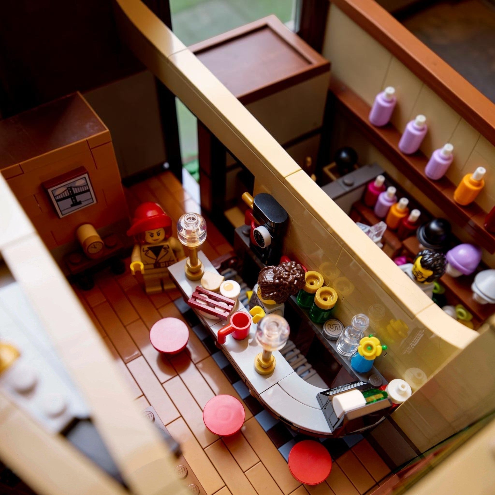 Close-up of a LEGO model of a bar with various bottles and glasses.
