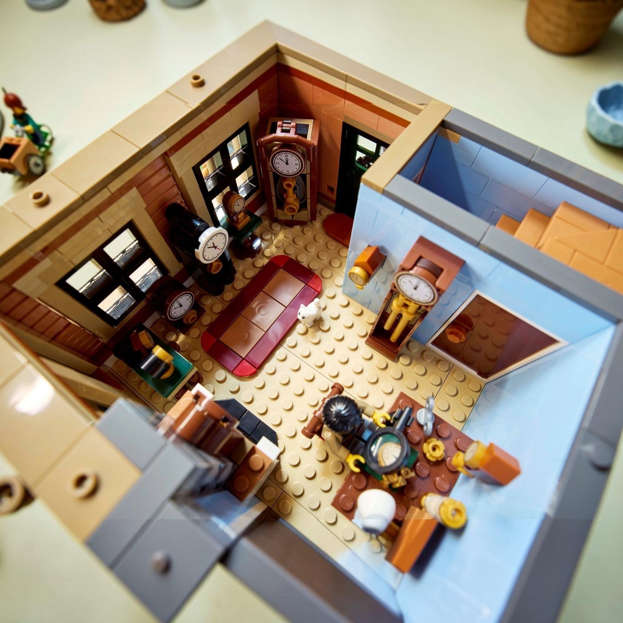 Close-up of a detailed LEGO model of an office with furniture and decor.