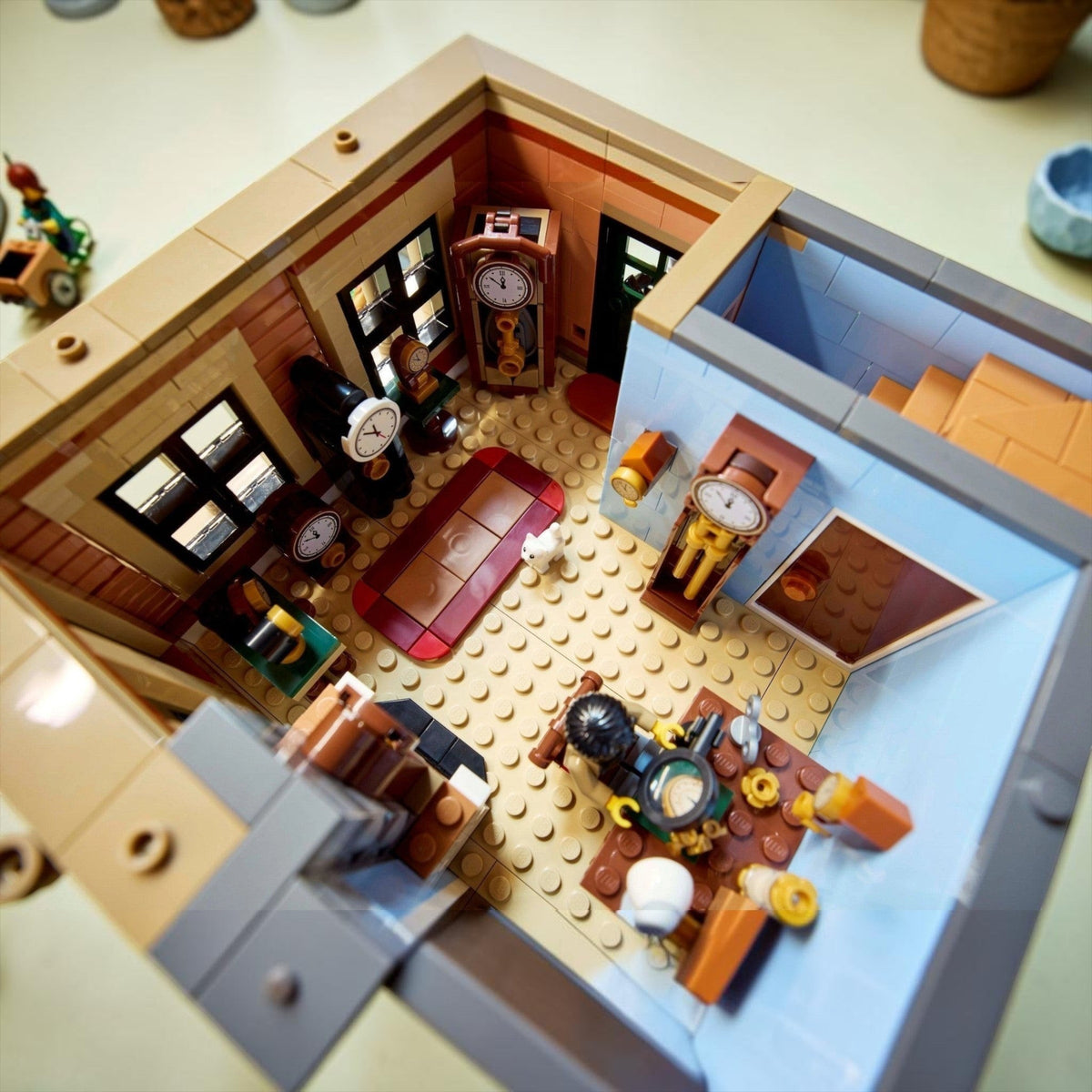 [built-detail] Close-up of a detailed LEGO model of an office with furniture and decor.