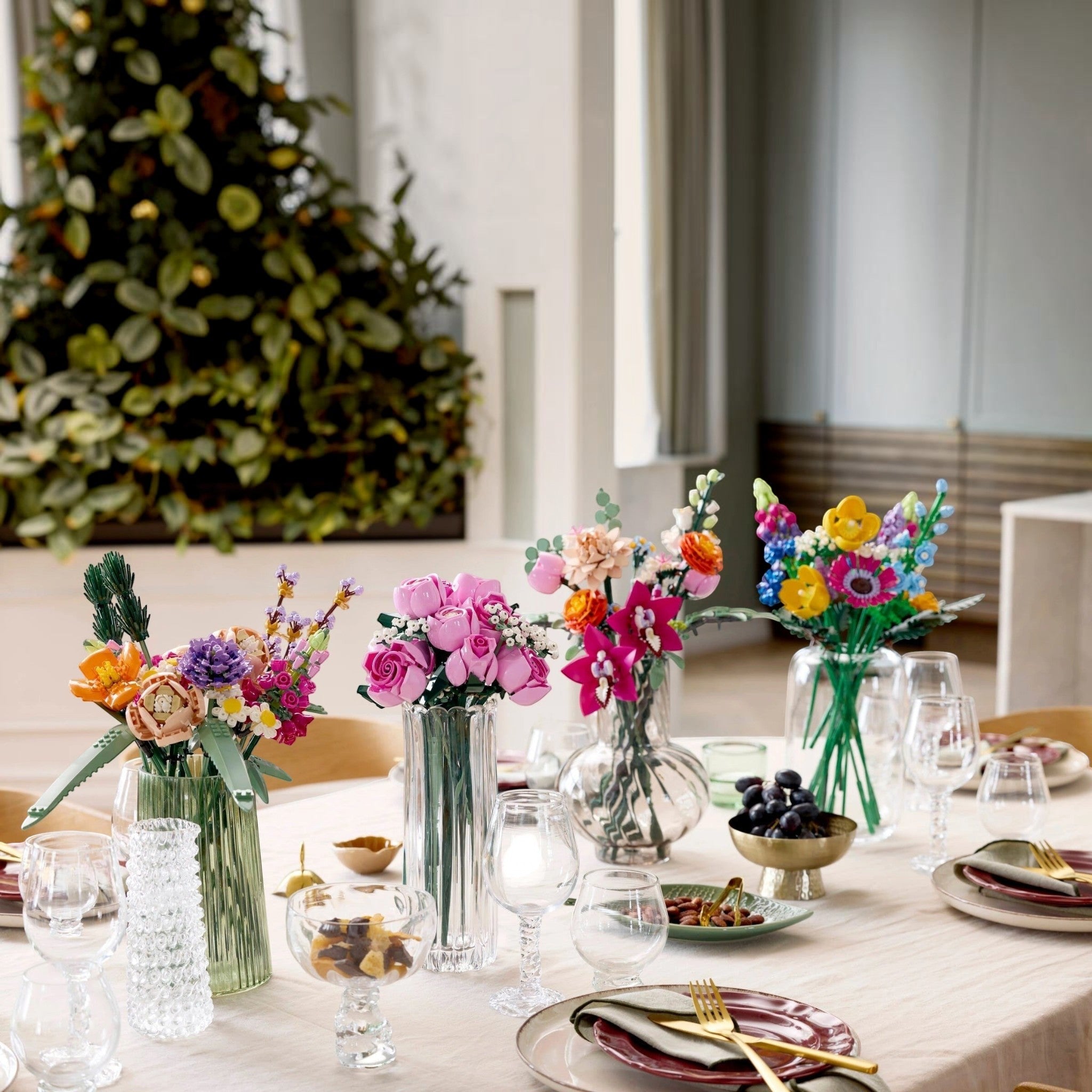Decorative table setting with colorful flower arrangements and tableware.