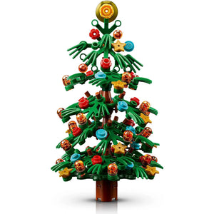 [built-detail] A toy building-block Christmas tree with green branches, a brown trunk, and colorful ornaments including red, blue, yellow, and orange pieces, shown on a white background.