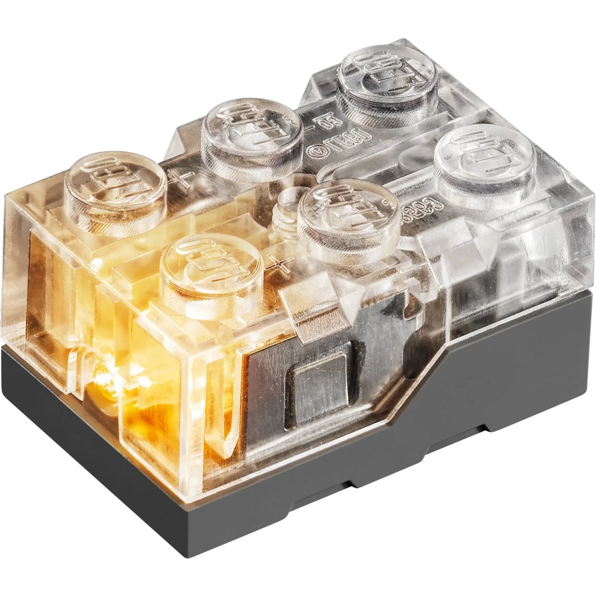 [built-detail] A LEGO light-up brick accessory, featuring a translucent clear top with glowing warm yellow internal LEDs and a solid dark gray base, shown on a white background.