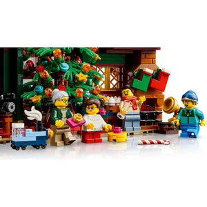 [built-detail] LEGO minifigures and holiday-themed building set displayed on a white background, featuring multiple assembled figures, a decorated Christmas tree, gifts, and a small cart.