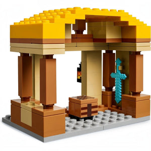 LEGO model of a desert temple with a yellow roof and brown pillars on a white background
