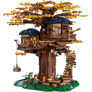[built-white] Toy treehouse with detailed architecture and small figures on a white background