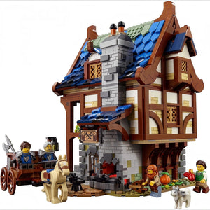 [built-white] LEGO model of a medieval-style house with characters and a cart on a white background
