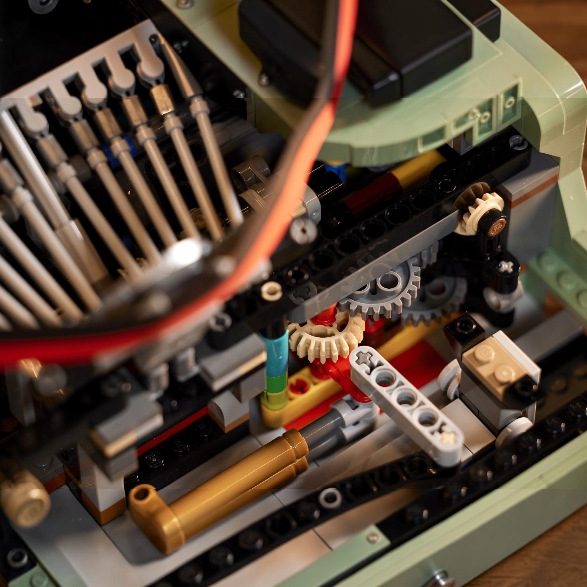 Close-up of a LEGO model with gears and mechanical components.