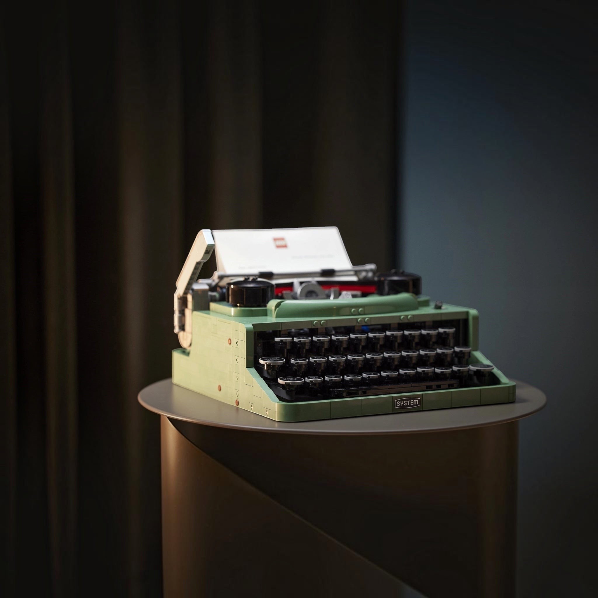 Green typewriter on a dark background