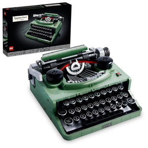 Green typewriter model with open lid showing internal components, displayed against a white background.