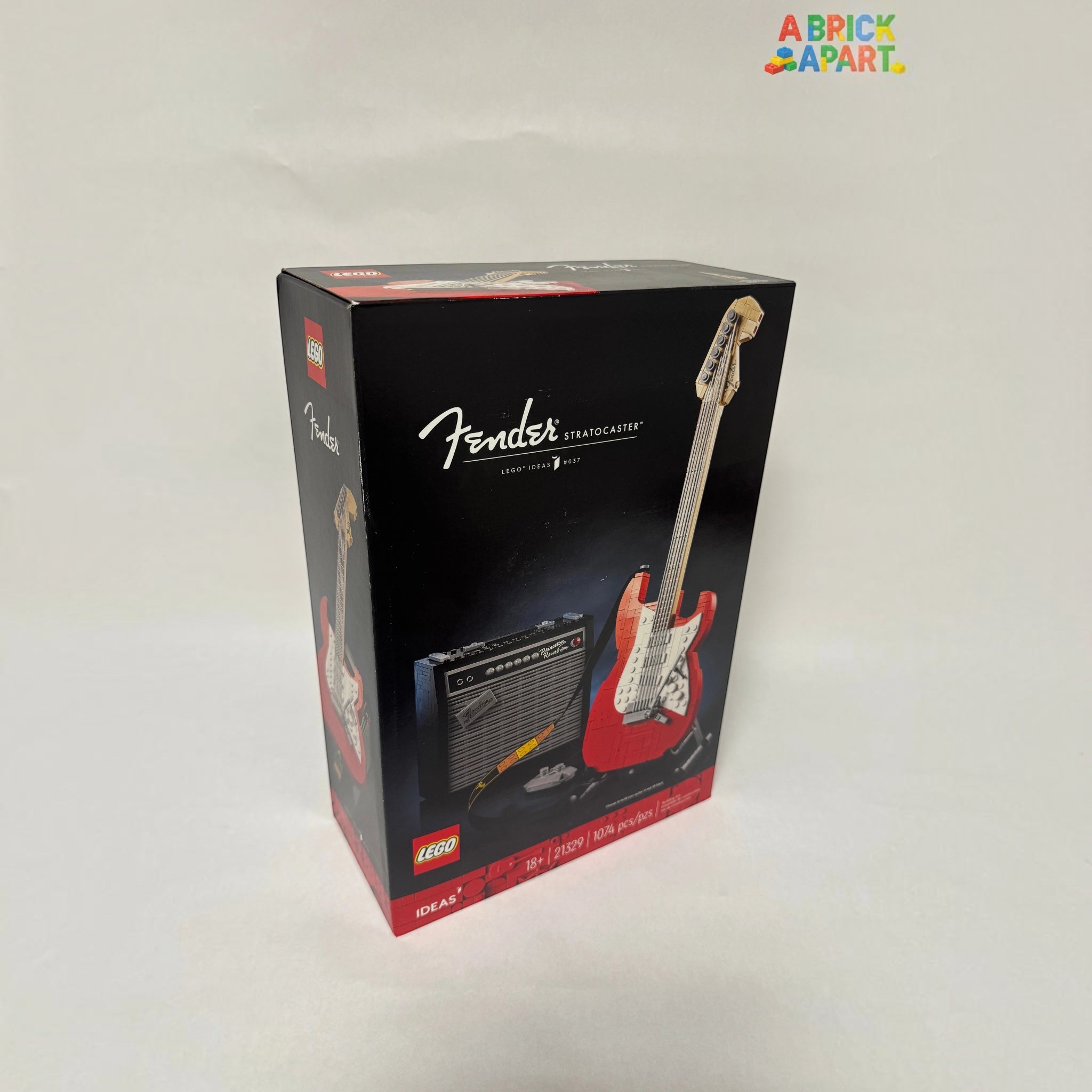Fender Stratocaster guitar and amplifier model in LEGO packaging on a white background