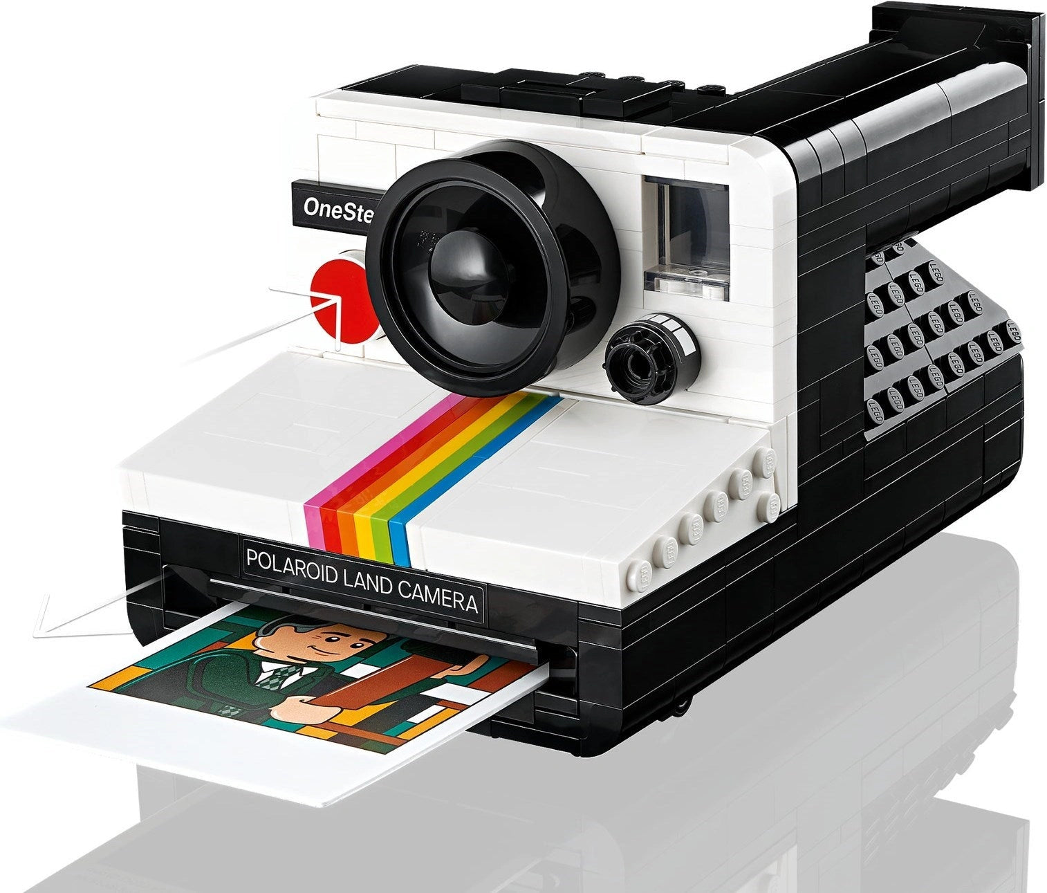 Polaroid Land Camera model with a printed photo on a white background