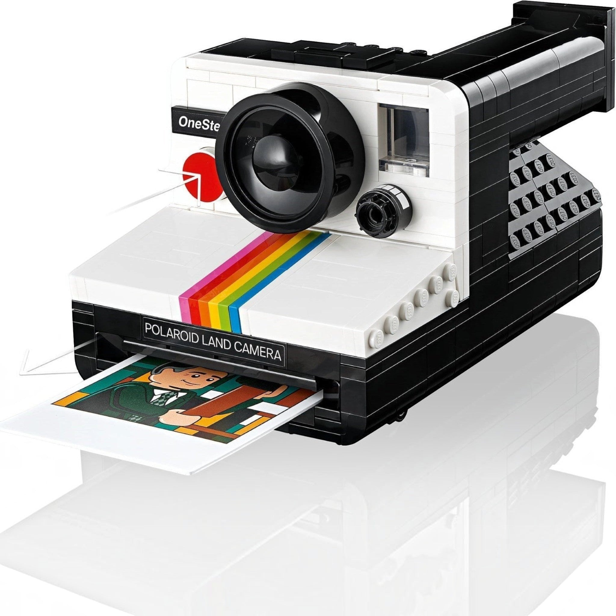 Polaroid Land Camera model with a printed photo on a white background
