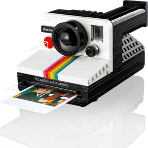 Polaroid Land Camera model with a printed photo on a white background