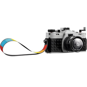 [built-detail] LEGO camera model with a strap on a white background
