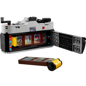 [built-white] LEGO set with a camera model and open display case on a white background