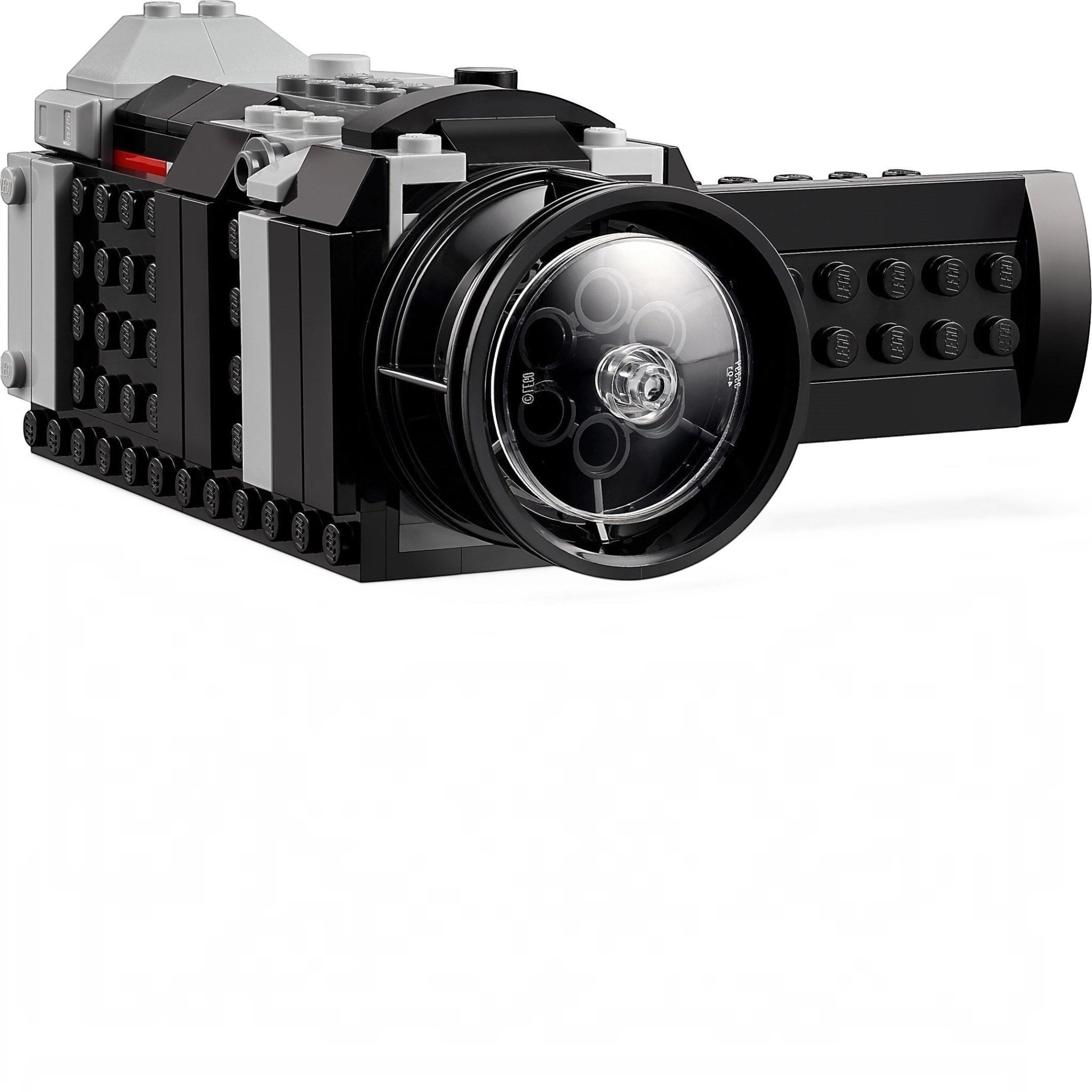 Toy camera made of interlocking bricks on a white background